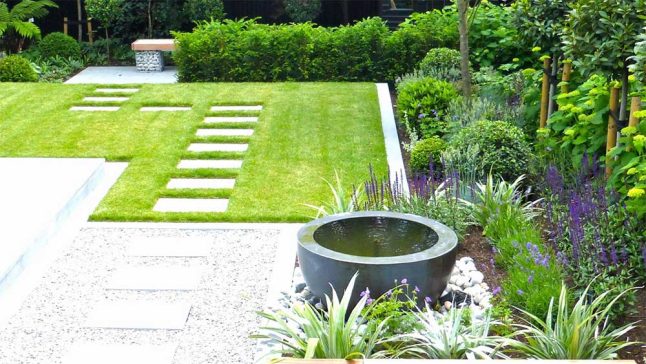 Gepflegter Privatgarten mit Trittplatten und Quellstein